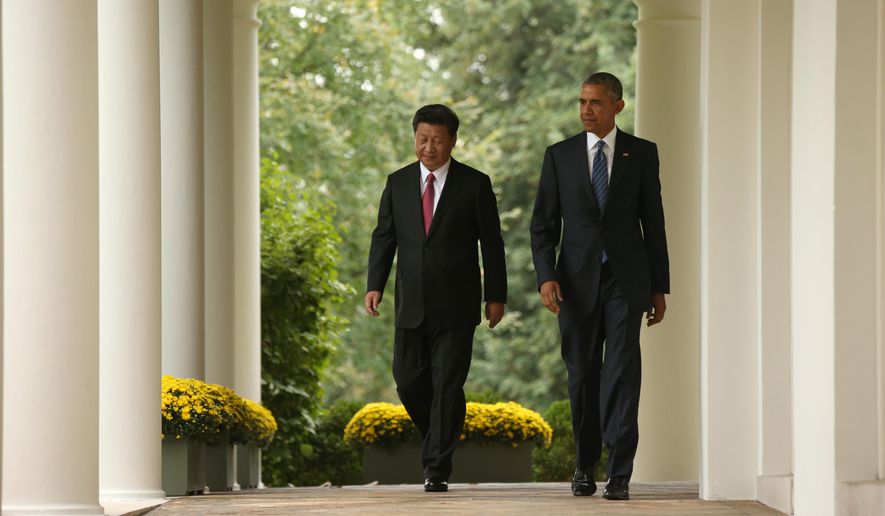 President Barack Obama and Chinese President Xi Jinping walk through the Colonnade of the White House in Washington, Friday, Sept. 25, 2015, for a news conference in the Rose Garden. (AP Photo/Andrew Harnik)