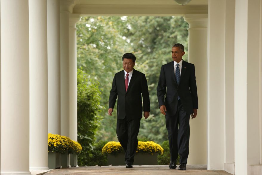 President Barack Obama and Chinese President Xi Jinping walk through the Colonnade of the White House in Washington, Friday, Sept. 25, 2015, for a news conference in the Rose Garden. (AP Photo/Andrew Harnik)