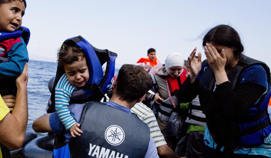 Syrian refugees arrive on the shores of the Greek island of Lesbos after crossing the Aegean sea from Turkey on an inflatable dinghy on Sept. 25, 2015. More than 260,000 asylum-seekers have arrived in Greece so far this year, most reaching the country's eastern islands on flimsy rafts or boats from the nearby Turkish coast. (Associated Press) **FILE**