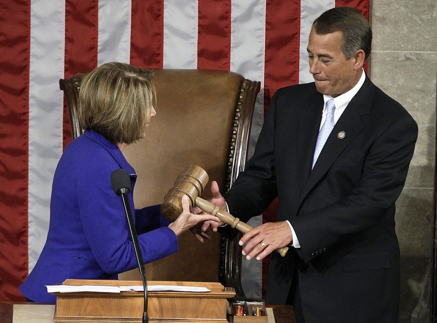 FILE - In this Jan. 5, 2011 file photo, then-outgoing House Speaker Nancy Pelosi of Calif. hands the gavel to the then-new House Speaker John Boehner of Ohio during the first session of the 112th Congress on Capitol Hill in Washington. Boehner’s announced exit as House speaker and from Congress altogether caps a political career that began as the head of a homeowners association in an Ohio neighborhood and made him second in line to the presidency. (AP Photo/Charles Dharapak, File)