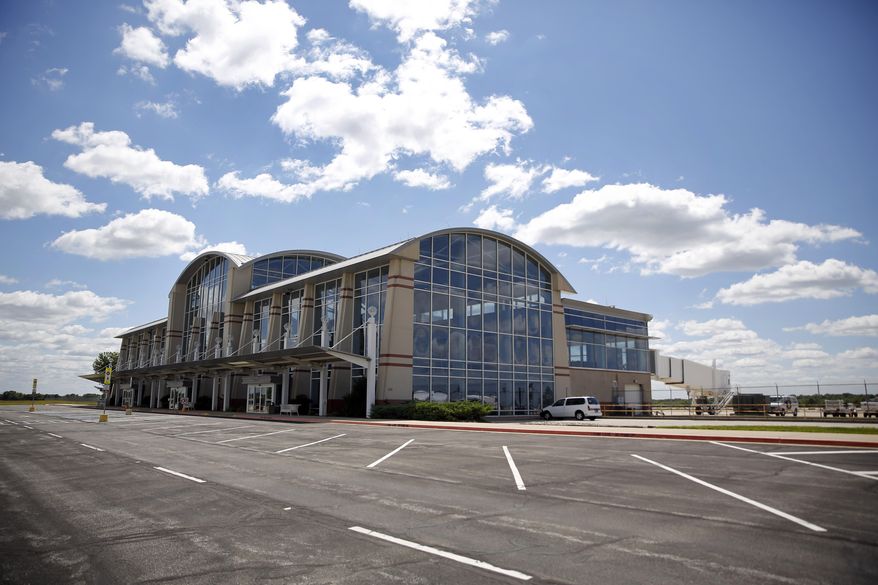 This photo taken Wednesday, Aug. 26, 2015, shows the terminal building at MidAmerica Airport in Mascoutah, Ill. In 1997 when the airport opened, supporters envisioned a facility that could one day attract 1 million flyers annually and accommodate 85 gates. Instead today, MidAmerica Airport has only two gates serving just one low-cost airline operating only a few flights a week. (AP Photo/Jeff Roberson)