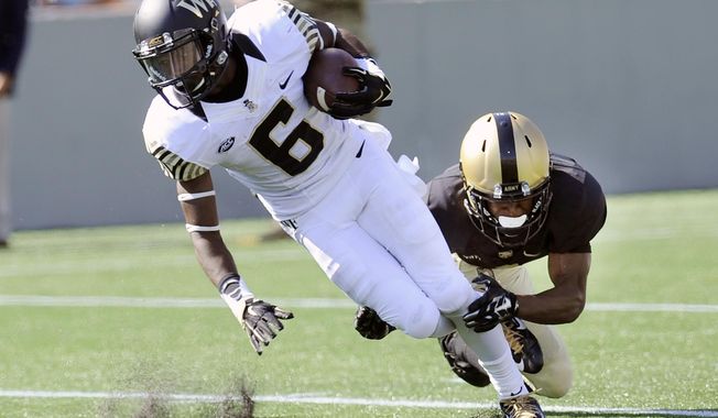 Wake Forest&#x27;s Tabari Hines (6) is tackled by Army&#x27;s Marcus Hyatt during the second half of an NCAA college football game on Saturday, Sept. 19, 2015, in West Point, N.Y. (AP Photo/Hans Pennink)