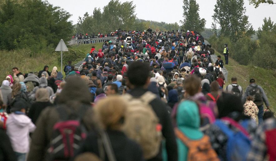 Migrants walk across a bridge in Botovo, Croatia, near the Hungarian border, Thursday, Sept. 24, 2015. (AP Photo/Darko Bandic) ** FILE **