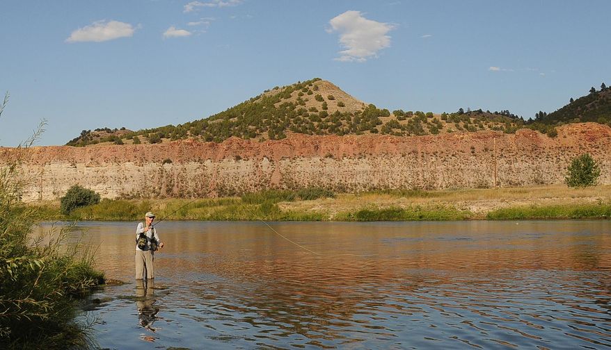 Billings fly fisherman John Kemmick wets his line on the Tongue River below the dam near Decker, Mont., Sept. 5, 2015. The river in southeastern Montana is often overlooked by anglers and floaters in favor of the state's more popular western streams, yet the Tongue provides a varied fishery and beautifully stark landscape. (Brett French/The Billings Gazette via AP) MANDATORY CREDIT