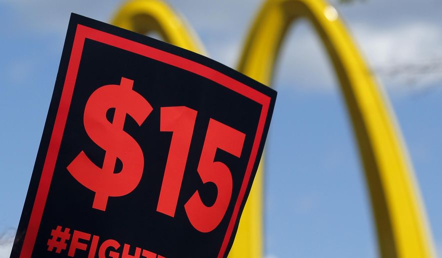 In this July 22, 2015, file photo, supporters of a $15 minimum wage for fast-food workers rally in front of a McDonald&#39;s in Albany, N.Y. (AP Photo/Mike Groll, File)