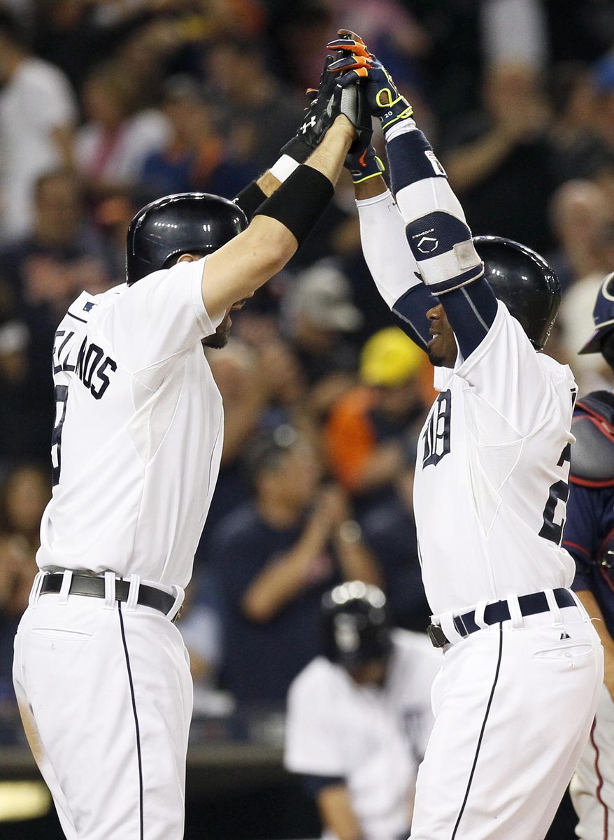Detroit Tigers' Rajai Davis, right, celebrates his two-run home run with teammate Nick Castellanos, left, during the eighth inning of a baseball game against the Minnesota Twins at Comerica Park, Friday, Sept. 25, 2015, in Detroit. (AP Photo/Duane Burleson)