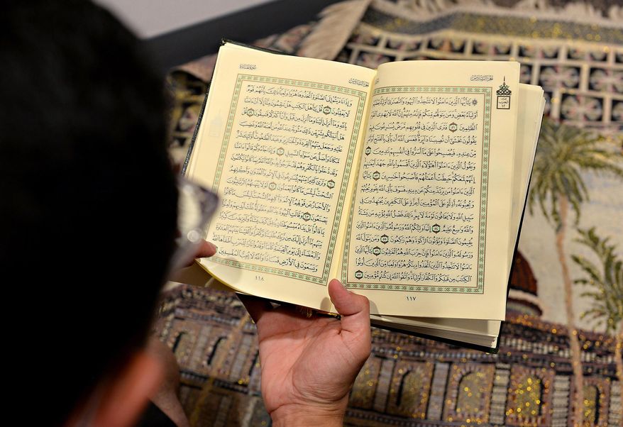 This photo taken June 1, 2015, shows Oregon State student Abdulrahman Alsulaim looking through the Qur'an while in a designated prayer area at the International Living Learning Center on campus in Corvallis, Ore. The Qur'an is the holy book for Muslims and is written in Arabic. (Amanda Cowan/The Corvallis Gazette-Times via AP)