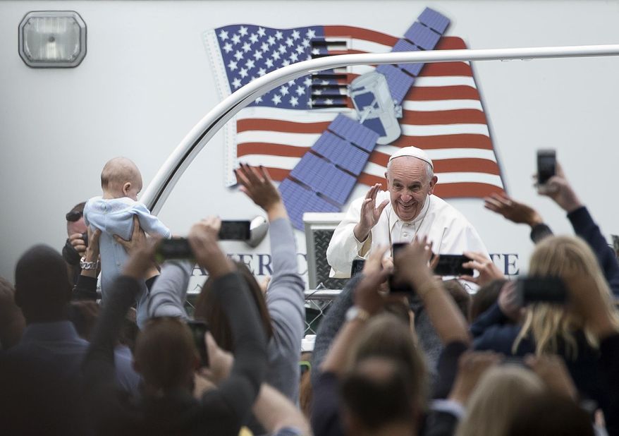 Pope Francis arrives for a Mass on the Benjamin Franklin Parkway, Sunday, Sept. 27, 2015, in Philadelphia. (AP Photo/Alessandra Tarantino)