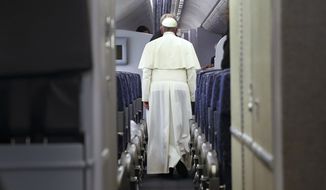 Pope Francis walks aboard the papal plane while en route to Italy, Monday, Sept. 28, 2015.  Pope Francis returned to the Vatican Monday at the end of a 10-day trip to Cuba and the United States. (Tony Gentile/Pool Photo via AP)