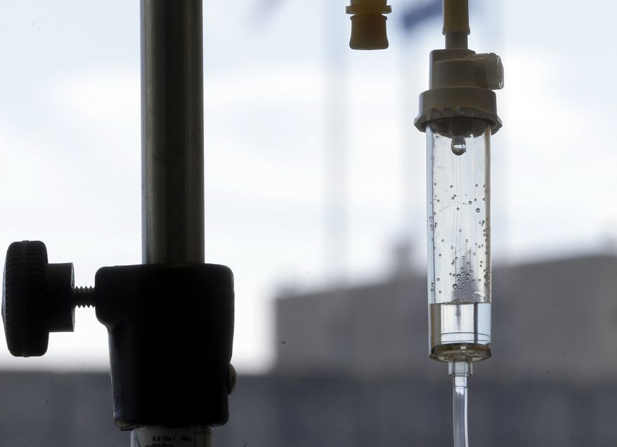 Chemotherapy is administered to a cancer patient via intravenous drip in Durham, N.C., in this Sept. 5, 2013, file photo. (AP Photo/Gerry Broome, File)