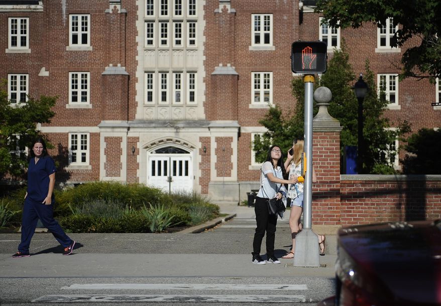 A surge of students from China is leading U.S. universities to confront the challenges of integrating them more into American campus life. (AP Photo/Jessica Hill)