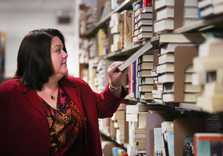 Deb Lambert, director of collection management for the Indianapolis Marion County Public Library for the past three years, looks over the books at the Library Services Center on Sept. 25, 2015. When a flap occurs at the library, the matter becomes the responsibility of  Lambert.  (Charlie Nye/The Indianapolis Star via AP)  NO SALES; MANDATORY CREDIT