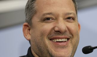 Tony Stewart smiles as he answers a question during a news conference to announce his retirement from driving NASCAR Sprint Cup series racing after the 2016 season at Stewart-Haas Racing&#39;s headquarters in Kannapolis, N.C., Wednesday, Sept. 30, 2015. (AP Photo/Chuck Burton)