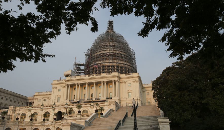 The west front of the U.S. Capitol is seen under repair Sept. 2, 2015 in Washington. (Associated Press) **FILE**