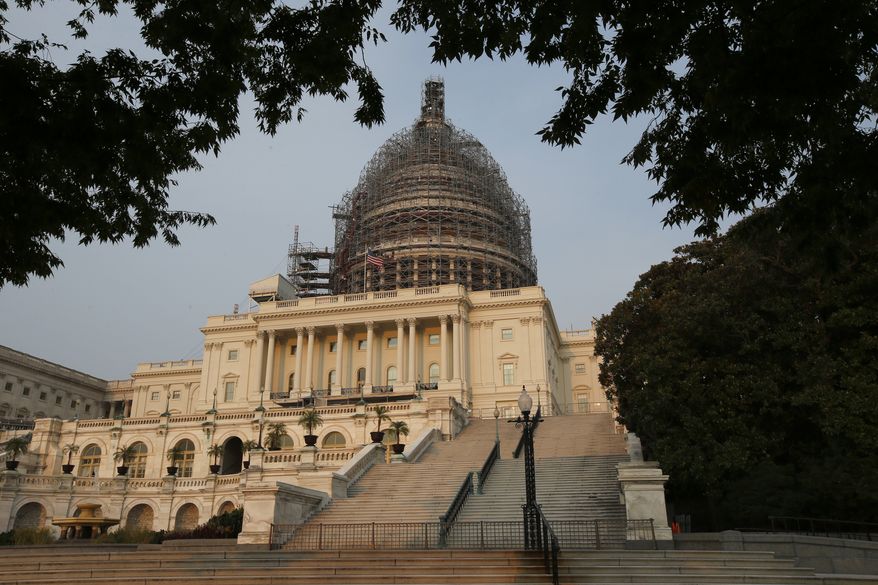 The west front of the U.S. Capitol is seen under repair Sept. 2, 2015 in Washington. (Associated Press) **FILE**