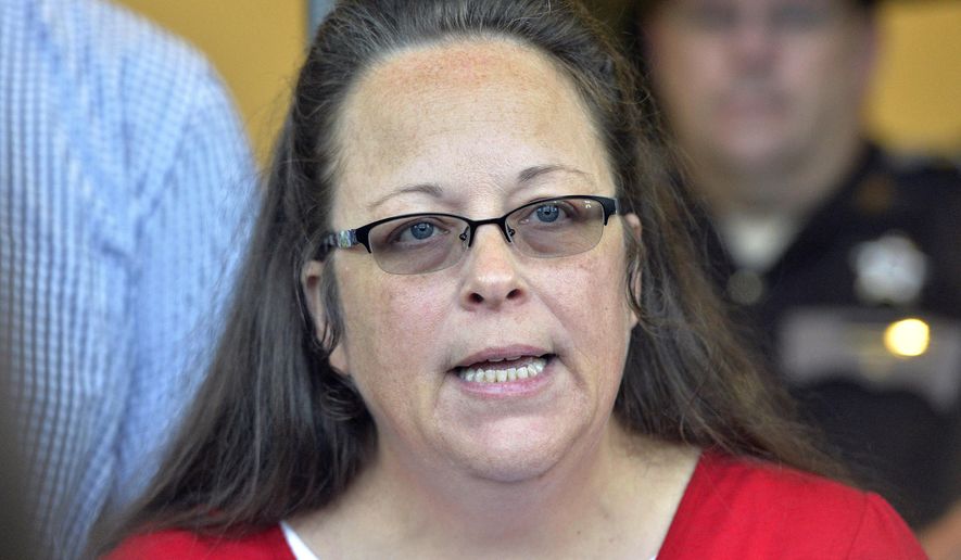 In this Sept. 14, 2015, file photo, Rowan County Clerk Kim Davis makes a statement to the media at the front door of the Rowan County Judicial Center in Morehead, Ky. Davis, who refused to issue marriage licenses to same-sex couples, says she met briefly with the pope during his historic visit to the United States. (AP Photo/Timothy D. Easley, File)