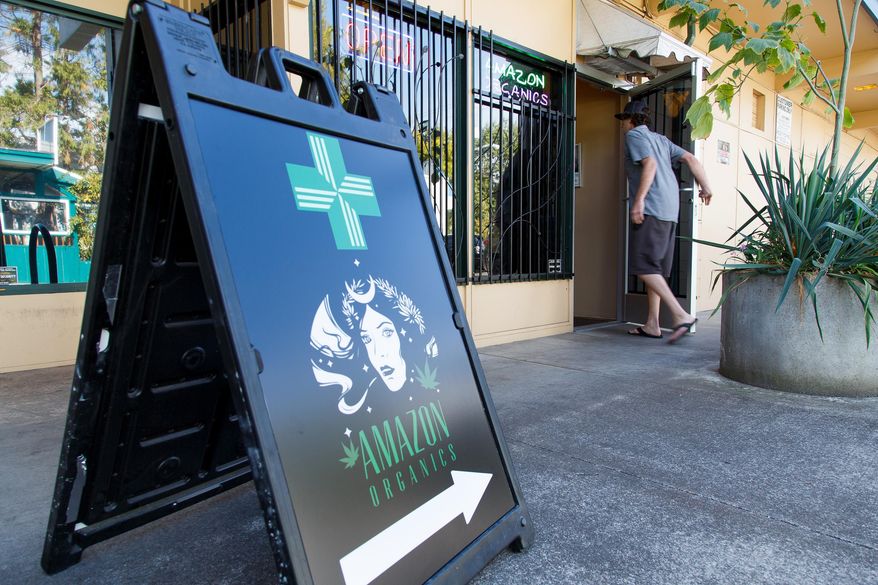 FILE - In this Monday, Sept. 28, 2015 file photo, a patient walks into Amazon Organics, a pot dispensary in Eugene, Ore. Medical marijuana dispensaries in Oregon will be able to sell recreational marijuana starting Thursday. (AP Photo/Ryan Kang)