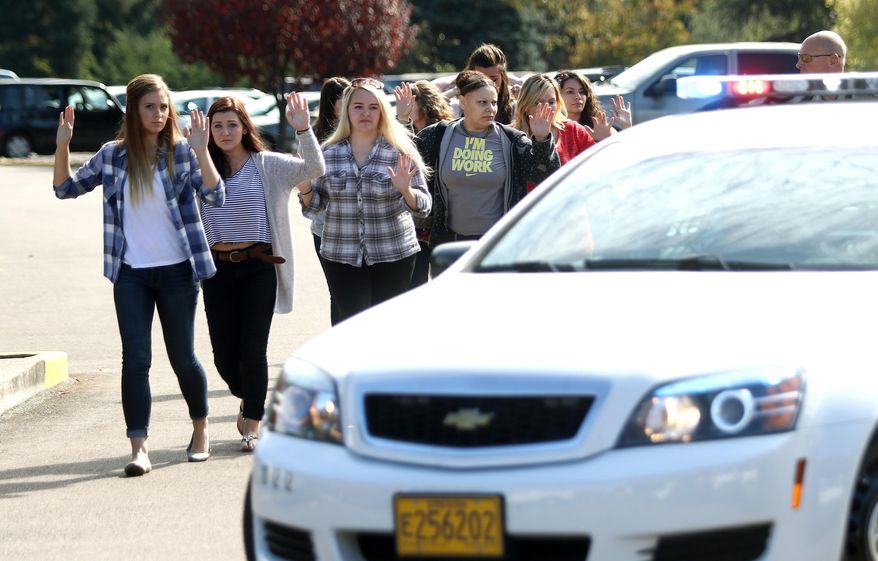 Students, staff and faculty are evacuated from Umpqua Community College in Roseburg, Ore. Thursday, Oct. 1, 2015, after a deadly shooting. (Michael Sullivan/The News-Review via AP) MANDATORY CREDIT