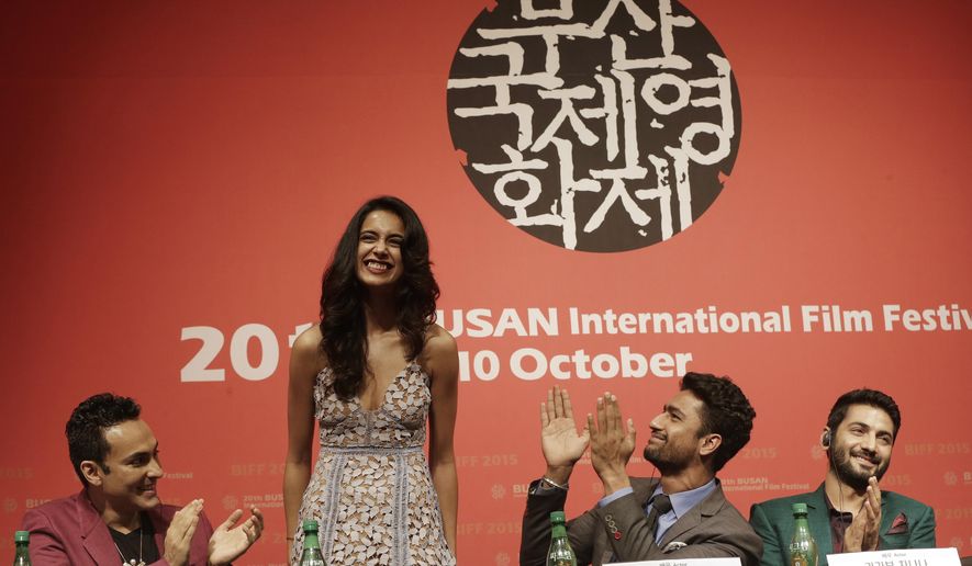 Indian actress Sarah Jane Dias, second from left, is congratulated by Indian director Mozez Singh, left, actor Vicky Kaushal and actor Raaghav Chanana , right, after she sings a song during a press conference for the Busan International Film Festival opening movie " Zubaan" in Busan, South Korea, Thursday, Oct. 1, 2015. (AP Photo/Ahn Young-joon)