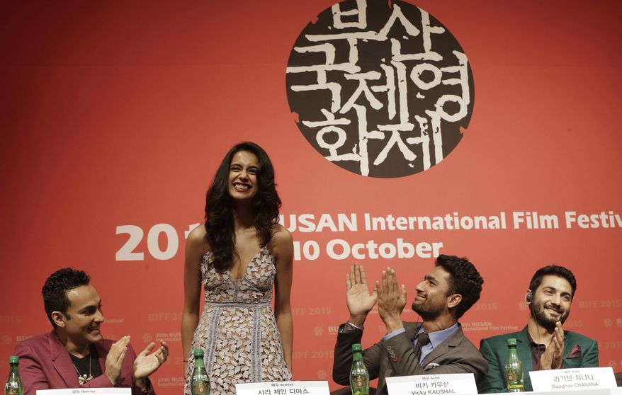 Indian actress Sarah Jane Dias, second from left, is congratulated by Indian director Mozez Singh, left, actor Vicky Kaushal and actor Raaghav Chanana , right, after she sings a song during a press conference for the Busan International Film Festival opening movie " Zubaan" in Busan, South Korea, Thursday, Oct. 1, 2015. (AP Photo/Ahn Young-joon)