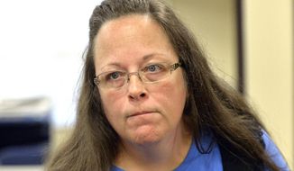 In this Tuesday, Sept. 1, 2015, file photo, Rowan County Clerk Kim Davis listens to a customer following her office&#39;s refusal to issue marriage licenses at the Rowan County Courthouse in Morehead, Ky. (AP Photo/Timothy D. Easley, File)