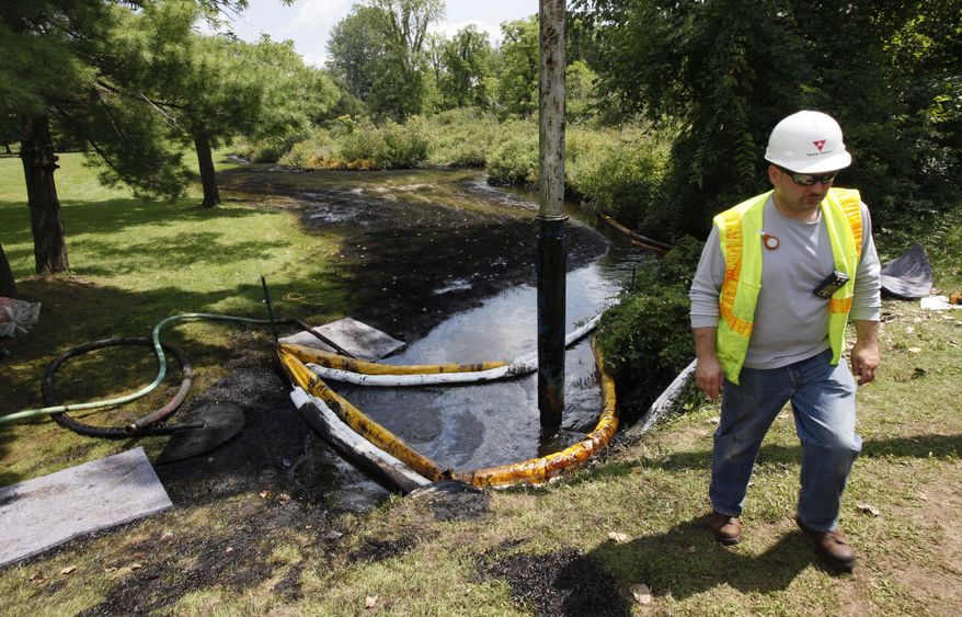 FILE - In this July 29, 2010 file photo, a worker monitors the water in Talmadge Creek in Marshall Township, Mich., near the Kalamazoo River as oil from a ruptured pipeline, owned by Enbridge Inc, is vacuumed out the water. The U.S. Department of Transportation wants to expand rules for pipelines carrying oil, gasoline and other hazardous liquids inspections requirements to include rural areas that are currently exempt, and for companies to more closely analyze the results of their inspections. (AP Photo/Paul Sancya, File)
