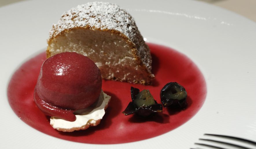 In this Sept. 17, 2015 photo, angel food cake with raspberry sorbet over a merengue and grapes is displayed at Felidia restaurant in New York. Restaurant owner Lidia Bastianich and restaurateur Angelo Vivolo, who served meals to Pope Benedict XVI, were chosen to prepare meals for Pope Francis during his time in New York. (AP Photo/Kathy Willens)
