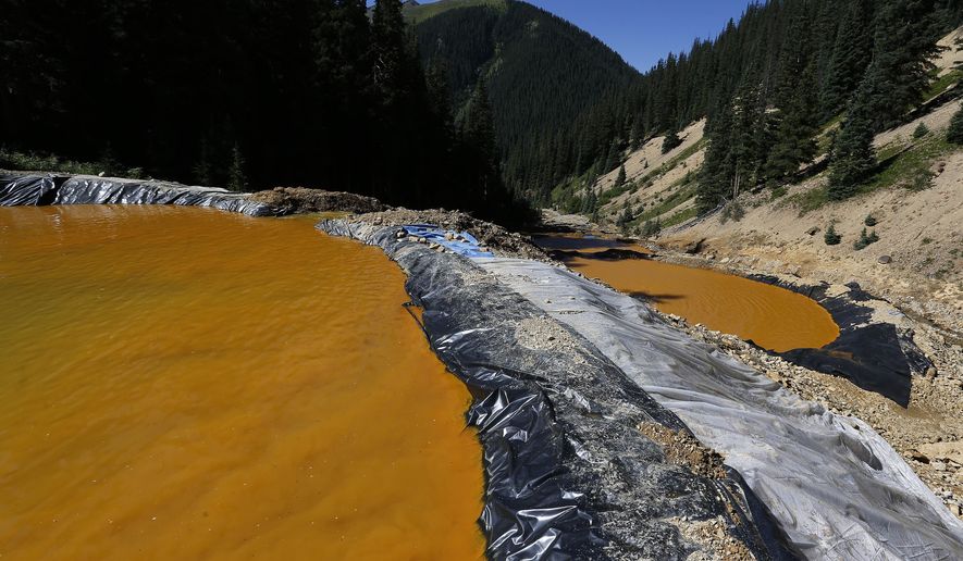 Water flows through a series of sediment retention ponds built to reduce heavy metal and chemical contaminants from the Gold King Mine wastewater accident, in the spillway about 1/4 mile downstream from the mine, outside Silverton, Colo., on Aug. 14, 2015. (Associated Press) **FILE**