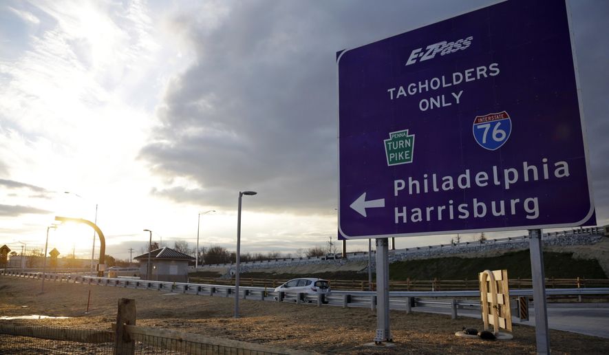 ADVANCE FOR WEEKEND EDITIONS OCT. 3-4 - FILE - In this file photo taken Dec. 11, 2012, a driver enters the Pennsylvania Turnpike at a newly completed E-ZPass Only electronic interchange in Malvern, Pa. The Pennsylvania Turnpike opened at one minute past midnight on Oct. 1, 1940, and marks its 75th anniversary in October 2015. (AP Photo/Matt Slocum, File)