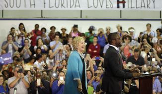 Democratic presidential candidate Hillary Rodham Clinton is introduced by honors student Darnell Joseph, 18, right, before speaking at a campaign event at Broward College, Friday, Oct. 2, 2015, in Davie, Fla. (AP Photo/Lynne Sladky)