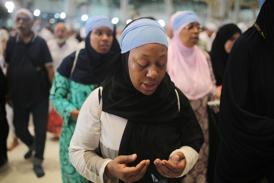 In this Monday, Sept. 21, 2015 photo, Shahidah Sharif circles the Kaaba, the cubic building at the Grand Mosque in the Muslim holy city of Mecca, Saudi Arabia. As Sharif, an African-American Muslim, joined millions of fellow pilgrims from around the world on the hajj this year, she felt a renewed connection. To her own “blackness,” she says, but also to humanity as a whole. (AP Photo/Mosa'ab Elshamy)