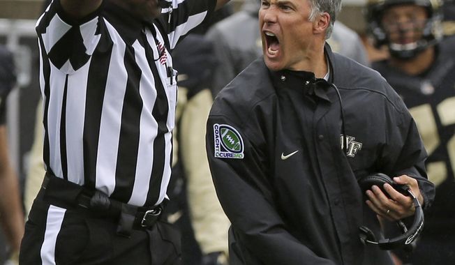 Wake Forest head coach Dave Clawson, right, argues a call during the second half of an NCAA college football game against Indiana in Winston-Salem, N.C., Saturday, Sept. 26, 2015. Indiana won 31-24. (AP Photo/Chuck Burton)