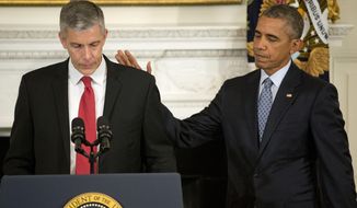 President Barack Obama pats Education Secretary Arne Duncan&#39;s back in the State Dining Room of the White House in Washington, Friday, Oct. 2, 2015, as Duncan  announced that he will be stepping down in December after 7 years in the Obama administration. Duncan will be returning to Chicago and Obama has appointed senior Education Department official, John King Jr., to oversee the Education Department. (AP Photo/Pablo Martinez Monsivais)