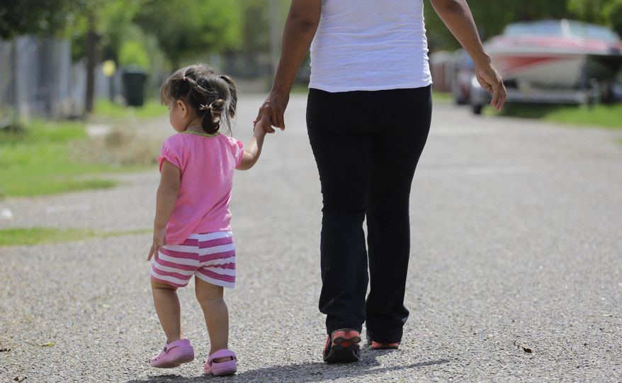 In this Wednesday, Sept. 16, 2015, photo, in Sullivan City, Texas, a woman who is in the country illegally walks with her 2-year-old daughter who was born in the in the United State but was denied a birth certificate. (AP Photo/Eric Gay) ** FILE **