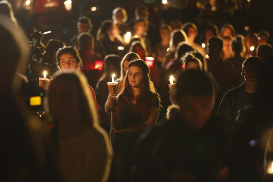People gather for a candlelight vigil at Stewart Park in Roseburg, Ore., after a shooting with multiple fatalities occurred at Umpqua Community College, Thursday, Oct. 1, 2015. (Randy L. Rasmussen/The Oregonian via AP)
