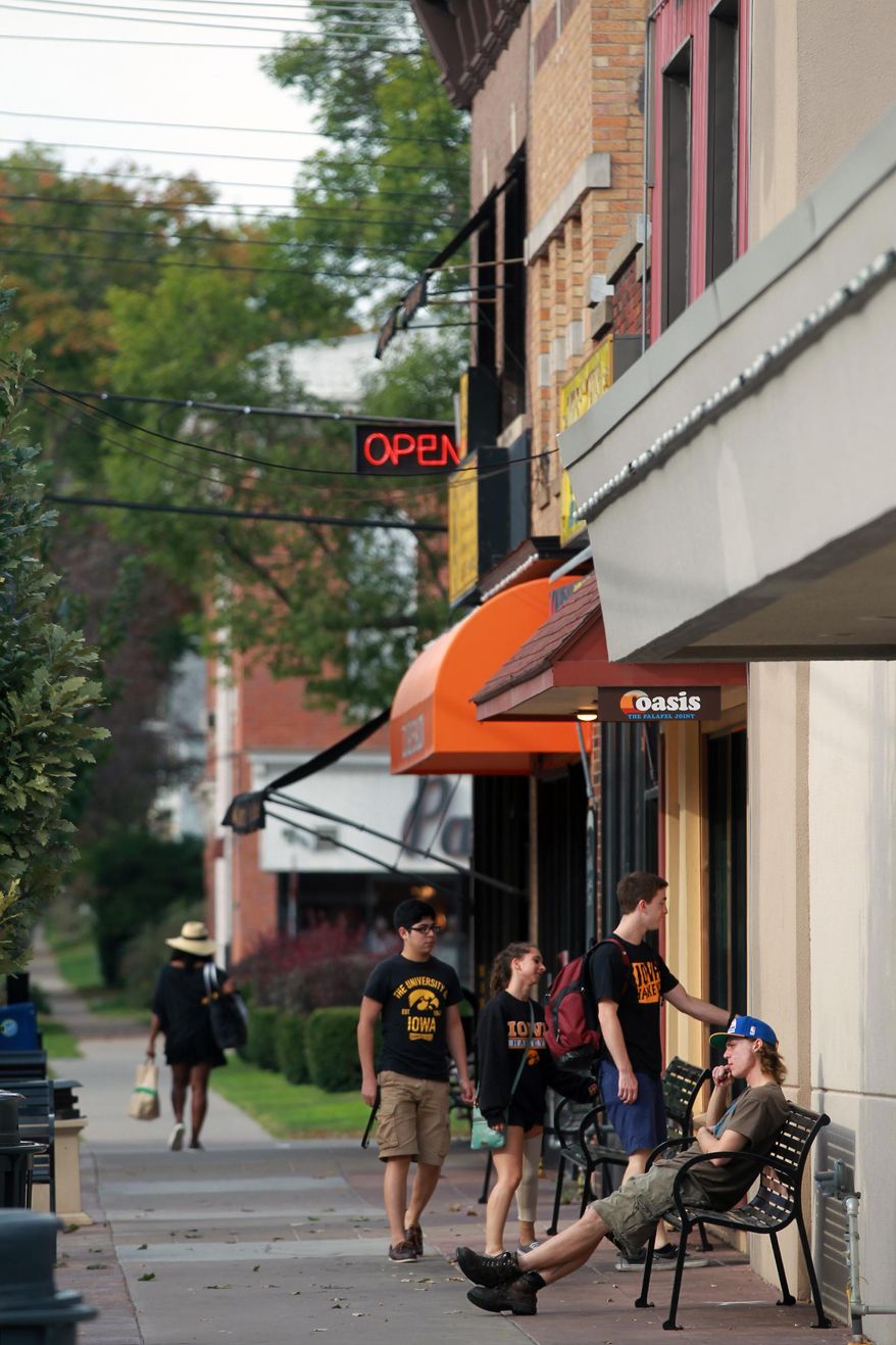 ADVANCE FOR USE SATURDAY, OCT. 3 - In this photo taken, Friday, Sept. 25, 2015, students head to Oasis for a meal on the northside of Iowa City, Iowa. Business owners and Downtown District leaders agree that development at the city's Northside Marketplace has built up the area's vibrancy and atmosphere. (David Scrivner/Iowa City Press-Citizen via AP) NO SALES; MANDATORY CREDIT