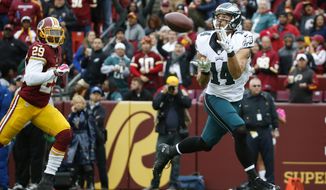 Philadelphia Eagles wide receiver Riley Cooper (14) pulls in a touchdown pass as Washington Redskins cornerback Chris Culliver (29) chases him during the second half of an NFL football game in Landover, Md., Sunday, Oct. 4, 2015. (AP Photo/Alex Brandon)