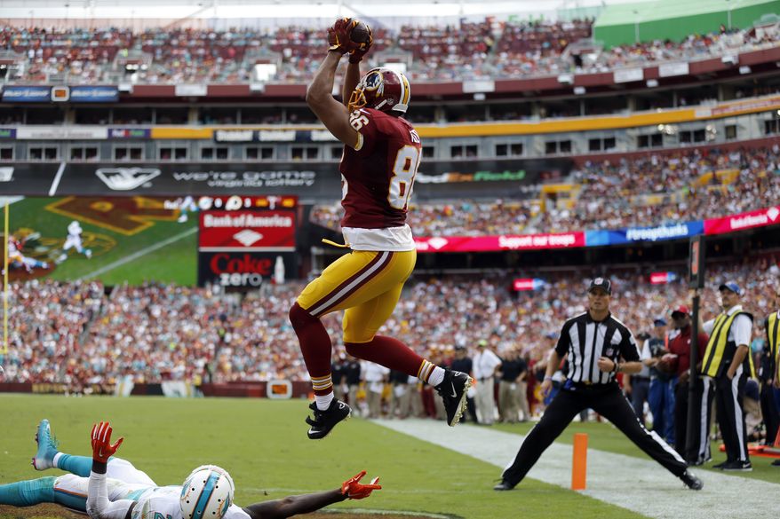 Washington Redskins tight end Jordan Reed (86) catches a touchdown pass over Miami Dolphins strong safety Reshad Jones (20) during the first half of an NFL football game Sunday, Sept. 13, 2015, in Landover, Md. (AP Photo/Patrick Semansky)