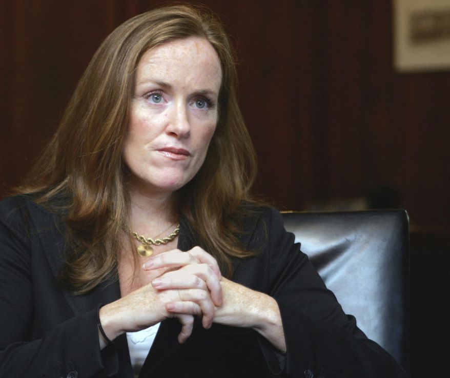 In this Sept. 14, 2006, file photo, Nassau County District Attorney Kathleen Rice listens to a reporter's questions in her Mineola, N.Y. office. Rice barred her prosecutors from keeping handguns, even at home; her office said the goal was safety. Although her successor, current acting Nassau County District Attorney Madeline Singas loosened the policy, prosecutors are still prohibited from carrying guns at work. (AP Photo/Ed Betz, File)