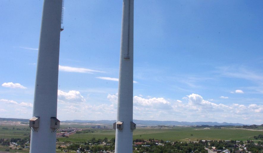 FILE - This July 1, 2013 file photo shows smokestacks at the Colstrip Steam Electric Station, in Colstrip, Mont. NorthWestern Energy makes its case to state regulators Tuesday, Oct. 6, 2015, in a dispute over at least $8.5 million that the utility collected from Montana customers after a 2013 power plant outage forced it to buy electricity on the open market. (AP Photo/Matthew Brown, File)