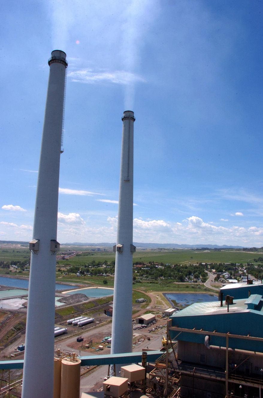 FILE - This July 1, 2013 file photo shows smokestacks at the Colstrip Steam Electric Station, in Colstrip, Mont. NorthWestern Energy makes its case to state regulators Tuesday, Oct. 6, 2015, in a dispute over at least $8.5 million that the utility collected from Montana customers after a 2013 power plant outage forced it to buy electricity on the open market. (AP Photo/Matthew Brown, File)