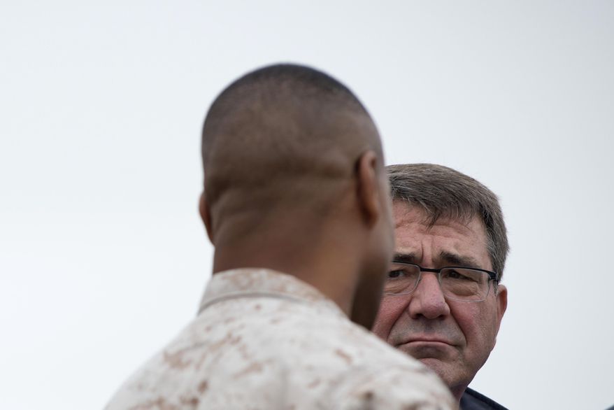 US Secretary of Defense Ashton Carter speaks with a US Marine during his visit at Moron Airbase, near Seville, Spain, Tuesday, Oct. 6, 2015. Carter is on a weeklong trip to Europe, including stops in Spain, Italy and London, and will also attend the NATO meeting, which is expected to focus on Russia's recent launch of military airstrikes in Syria. (AP Photo/Laura Leon)