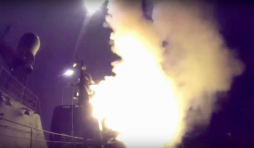 Russian naval ships launched cruise missiles Wednesday as President Vladimir Putin&#39;s military bombarded parts of Syria by air, land and sea, claiming Islamic State militants were the targets. (Associated Press)