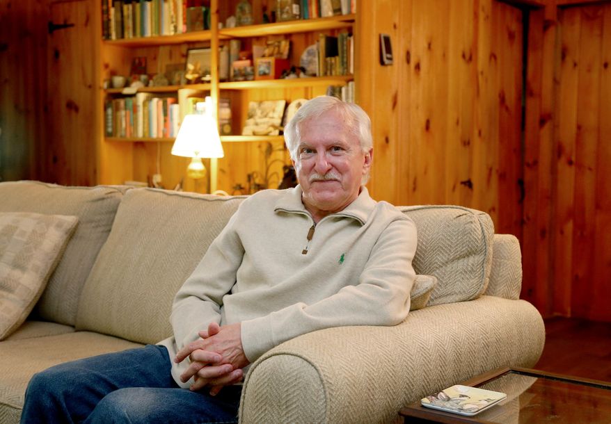 Paul Modrich poses for a photo on a couch at his vacation home, Wednesday, Oct. 7, 2015, in Rumney, N.H. Modrich, an investigator at Howard Hughes Medical Institute and professor at Duke University School of Medicine in Durham, N.C., is one of three scientists who won the Nobel Prize in chemistry on Wednesday for showing how cells repair damaged DNA, work that has inspired the development of new cancer treatments. (AP Photo/Mary Schwalm)