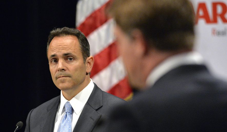 Kentucky Republican gubernatorial candidate Matt Bevin, left, listens to a reply from his opponent, Democratic candidate Jack Conway during the 2015 Kentucky Gubernatorial Debate hosted by Centre College, Tuesday, Oct. 6, 2015, in Danville, Ky. (AP Photo/Timothy D. Easley)