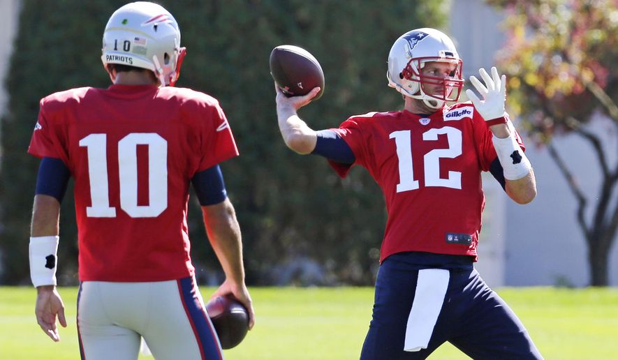 New England Patriots quarterback Tom Brady  throws a pass as back-up quarterback Jimmy Garoppolo (10) watches during an NFL football practice in Foxborough, Mass., Wednesday, Oct. 7, 2015. The Patriots will travel to Dallas to face the Cowboys on Sunday. At rear left is offensive coordinator Josh McDaniel. (AP Photo/Charles Krupa)