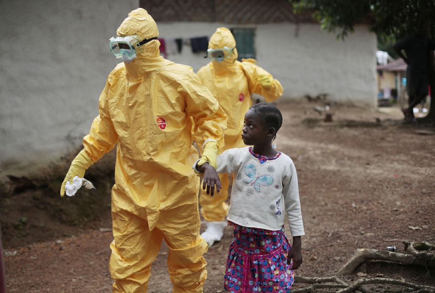 FILE - In this Tuesday, Sept. 30, 2014 file photo, Nine-year-old Nowa Paye is taken to an ambulance after showing signs of the Ebola infection in the village of Freeman Reserve, about 30 miles north of Monrovia, Liberia. The World Health Organization says there were no Ebola cases reported last week - the first time an entire week has passed without any new confirmed patients since the devastating outbreak began last March. The U.N. health agency said in a report issued Wednesday, Oct. 7, 2015 that all contacts of Ebola cases in Sierra Leone have now been followed for 21 days without falling sick, suggesting the country might soon be free of the disease. (AP Photo/Jerome Delay, File)