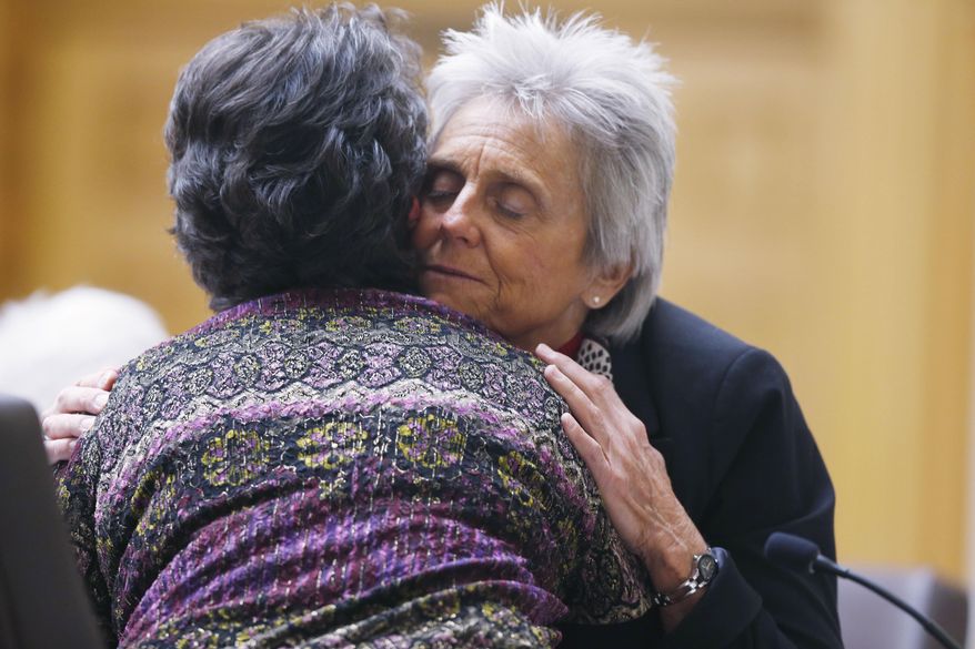FILE - In this Feb. 6, 2015 file photo, Colorado Rep. Joann Ginal, right, D-Fort Collins, hugs Carol Stork of Delta, Colo., after her testimony about the death of her terminally-ill husband Albert, during a Colorado legislative hearing on a bill proposal by Ginal that would give dying patients the option to seek help ending their lives, in Denver. Colorado Democrats will consider legislation in 2016 to allow terminally ill patients to end their lives with doctor-prescribed medication. A similar proposal last year failed, with opposition from both parties, but supporters of the idea are hoping California's passage of right-to-die legislation will give momentum to their cause. (AP Photo/David Zalubowski, file)