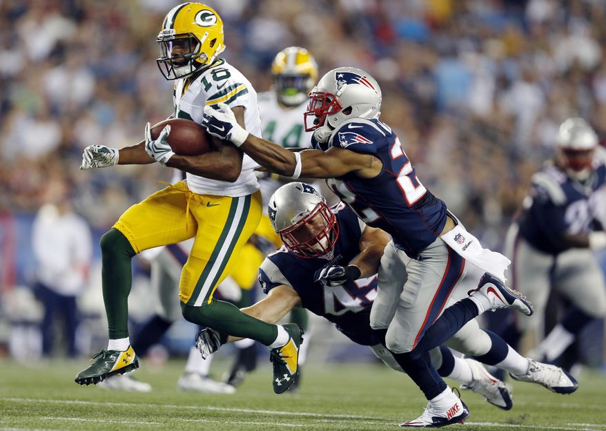 FILE - In this Aug. 13, 2015, file photo, New England Patriots defenders Robert McClain (22) and Cameron Gordon (45) chase down Green Bay Packers wide receiver Randall Cobb (18) during the first half of an NFL preseason football game in Foxborough, Mass. Playing receiver for the Packers is increasingly becoming a painful job. Cobb is limited with a right shoulder injury. (AP Photo/Michael Dwyer, File)