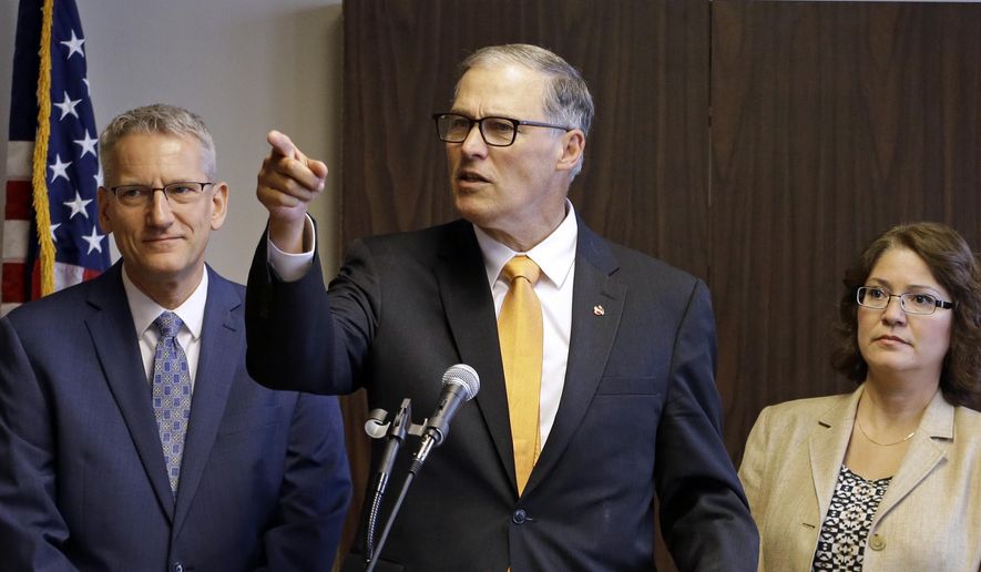 Washington Gov. Jay Inslee, center, addresses a news conference as state Health Secretary John Wiesman, left, and Ecology Director Maia Bellon look on Thursday, Oct. 8, 2015, in Seattle. Inslee directed state officials to attempt another rewrite of the state’s clean-water rules, as the state races to finalize a plan before the federal government does it for Washington. The contentious rule has pitted tribes against major businesses such as Boeing. (AP Photo/Elaine Thompson)